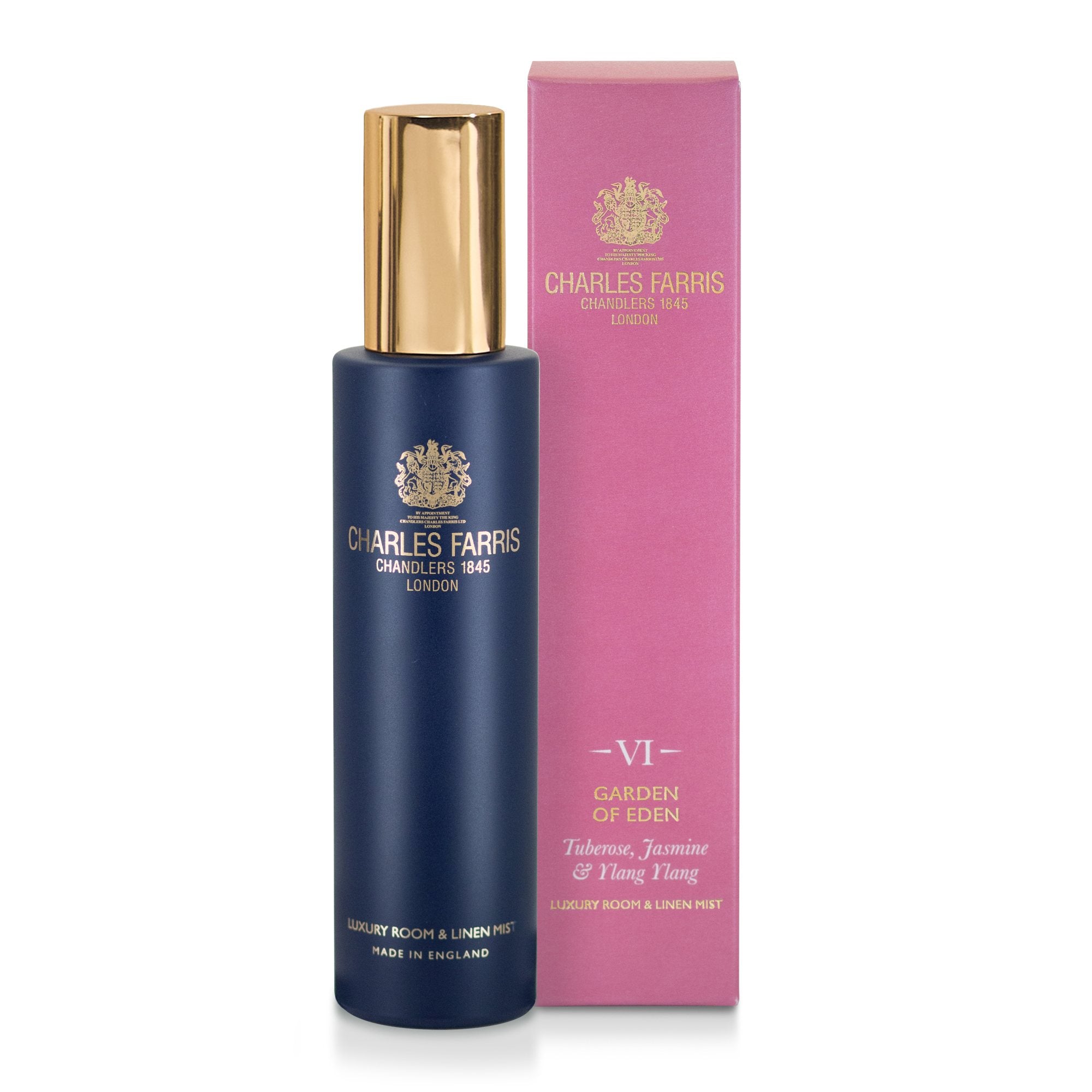 Charles Farris Garden of Eden tuberose, Yasmine, Ylang Yang room mist scented home spray in navy blue bottle next to its pink packaging.