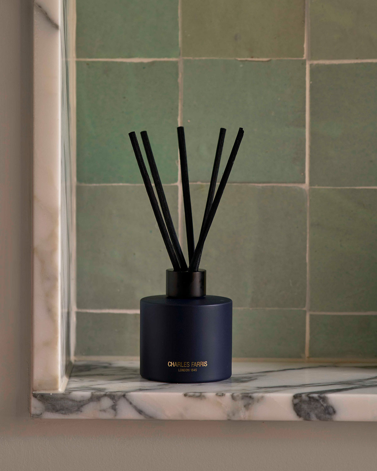 Charles Farris reed diffuser home fragrance on marble surface 