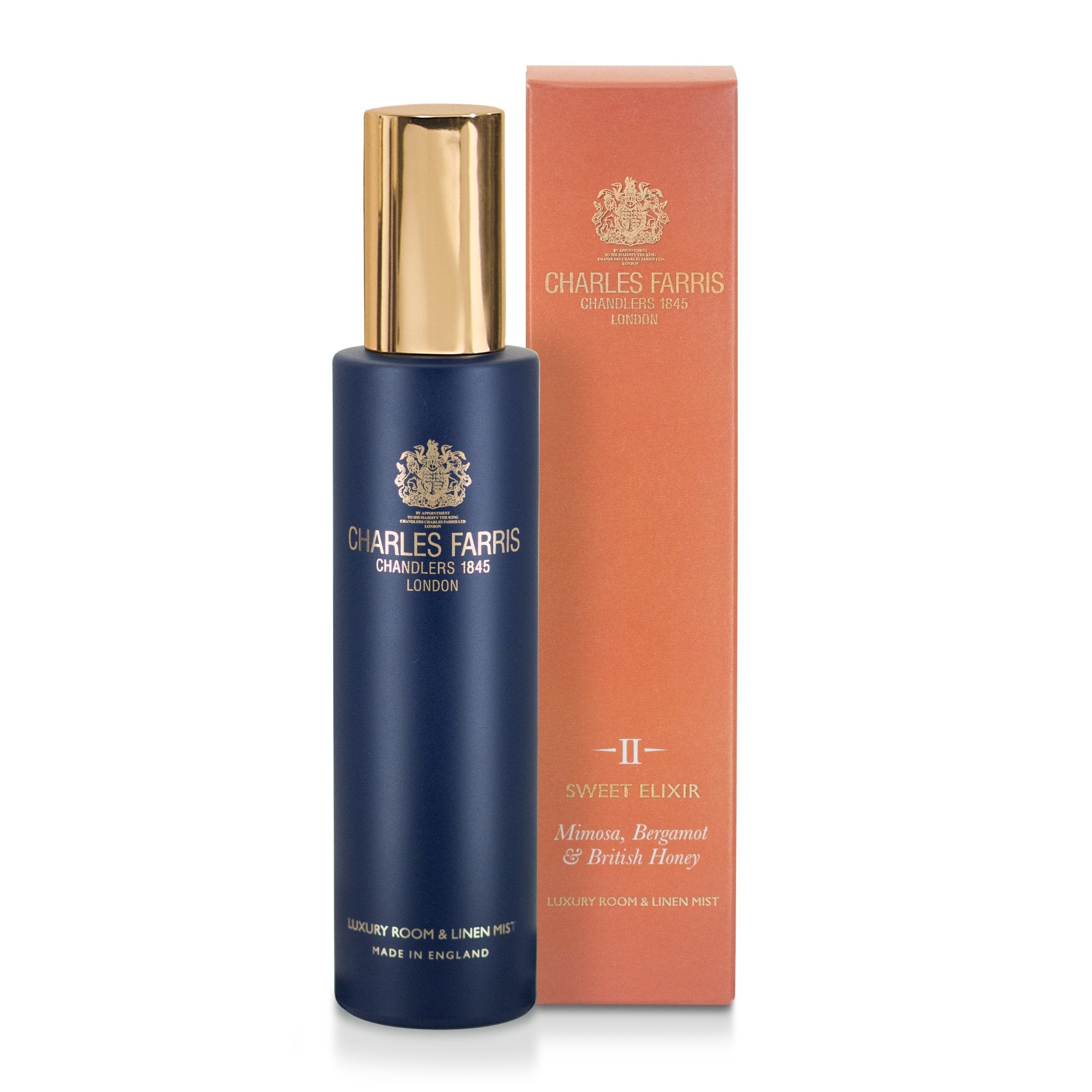 Charles Farris Sweet Elixir room spray premium fragrance home mist with mimosa, bergamot & British honey in a navy blue bottle next to its orange packaging box, on a white background.