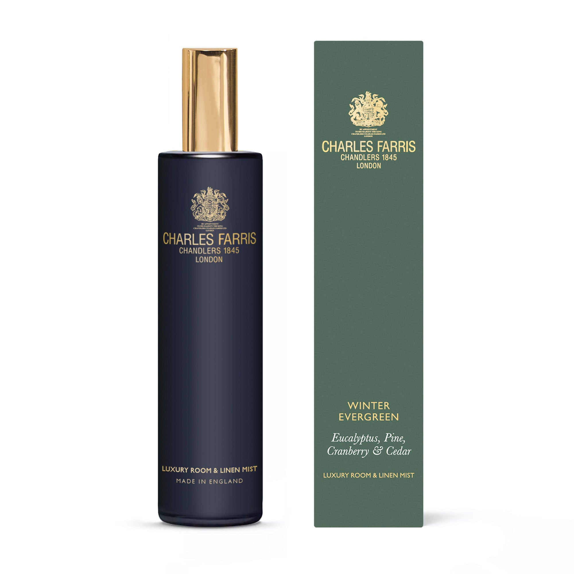 Charles Farris Winter Evergreen eucalyptus, pine, cranberry & cedar room mist scented home spray next to it's green packaging.