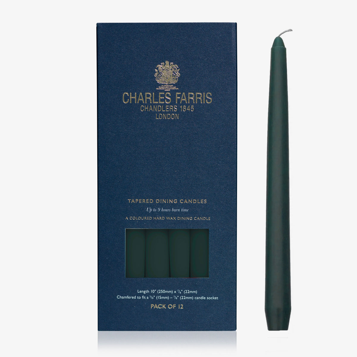 Charles Farris dark evergreen tapered dinner candle beside its navy box, pack of 12, 9 hour burn, made in England