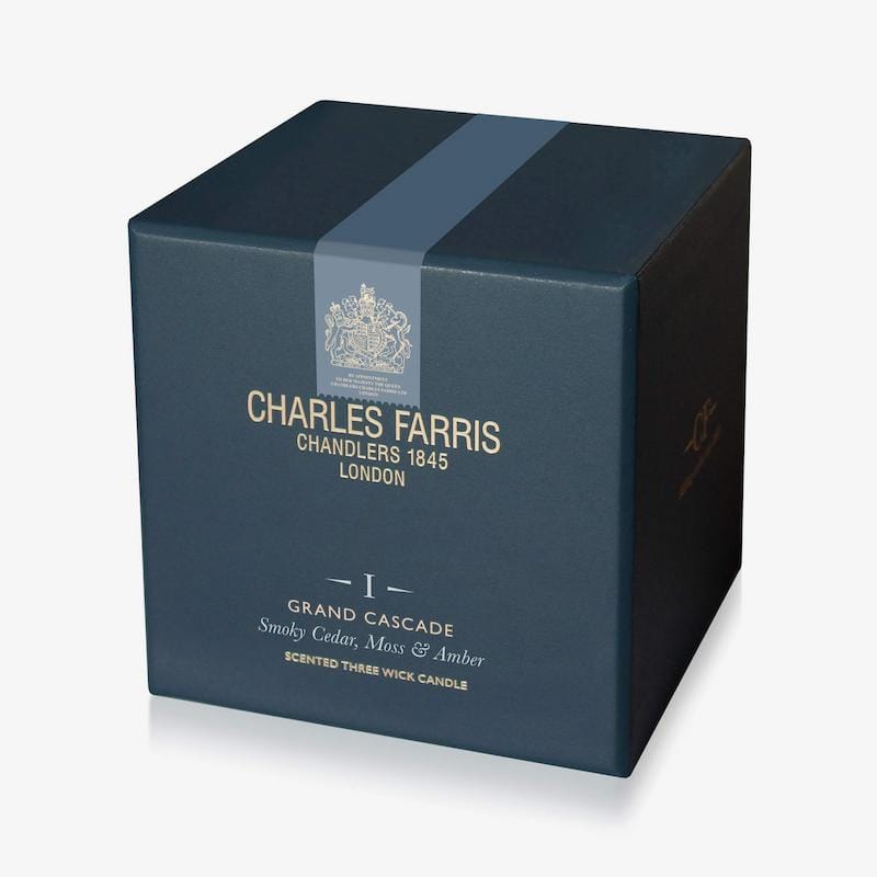 Blue box of Charles Farris candle with branding and product details on a white background