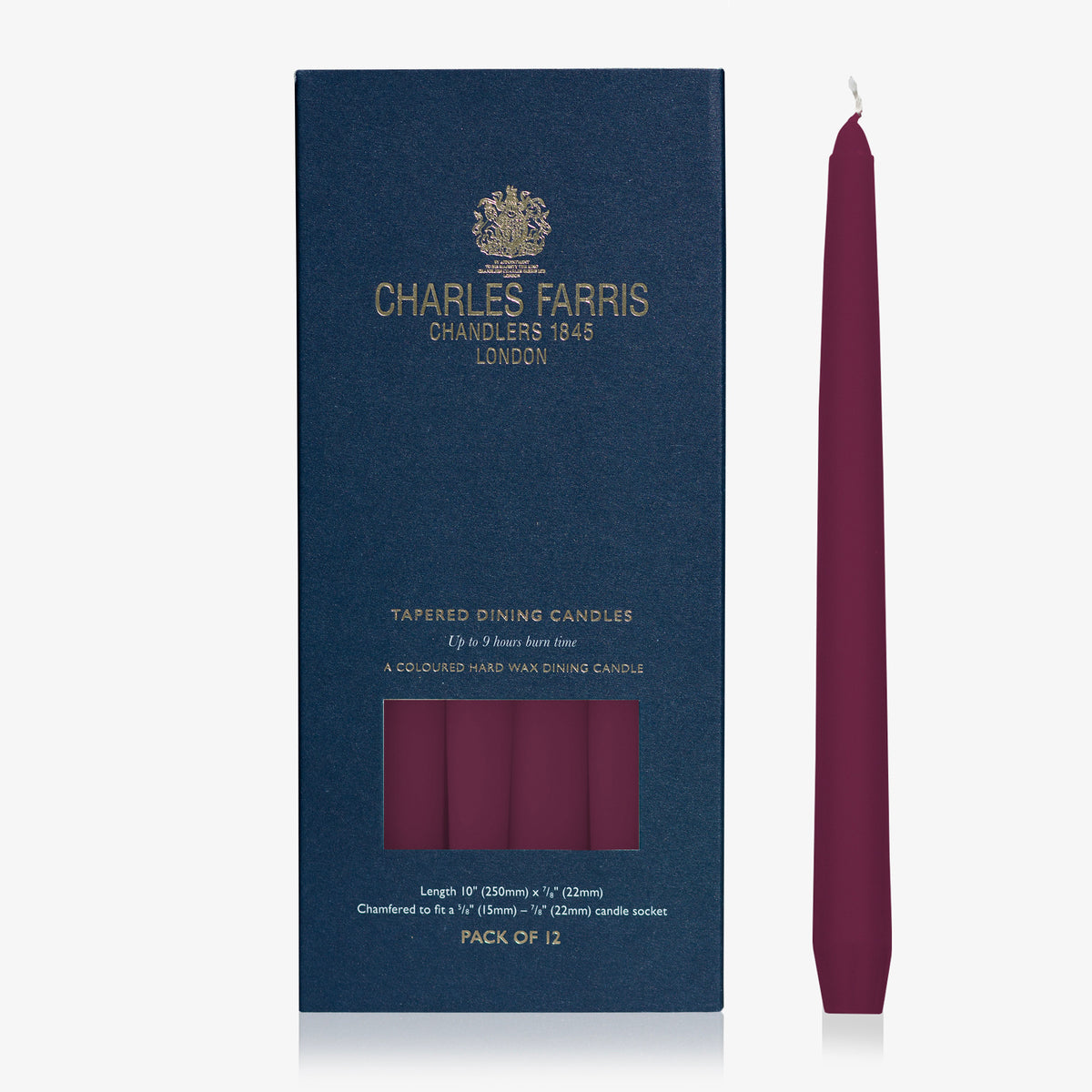 Charles Farris rose plum tapered dinner candle beside its navy box, pack of 12, 9 hour burn, made in England