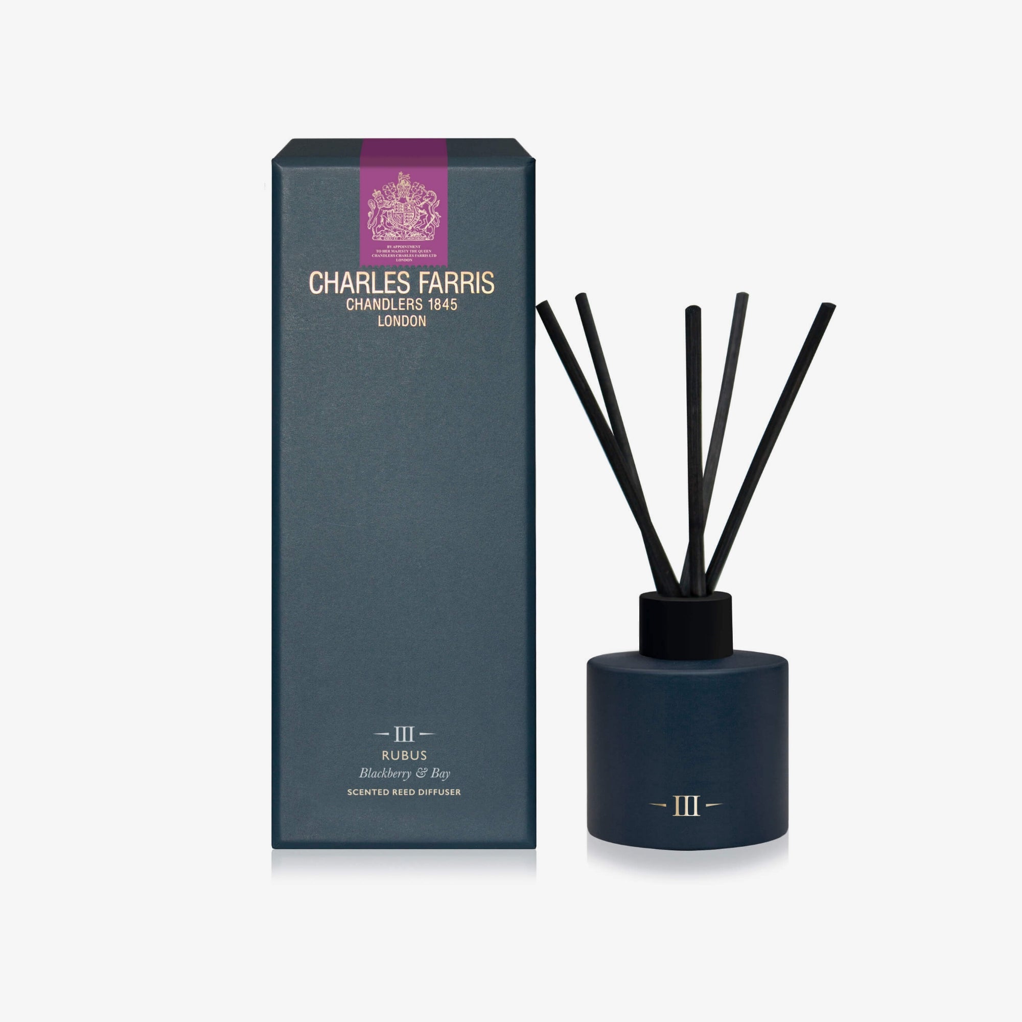 Diffuser with black sticks and a blue container next to its packaging on a white background