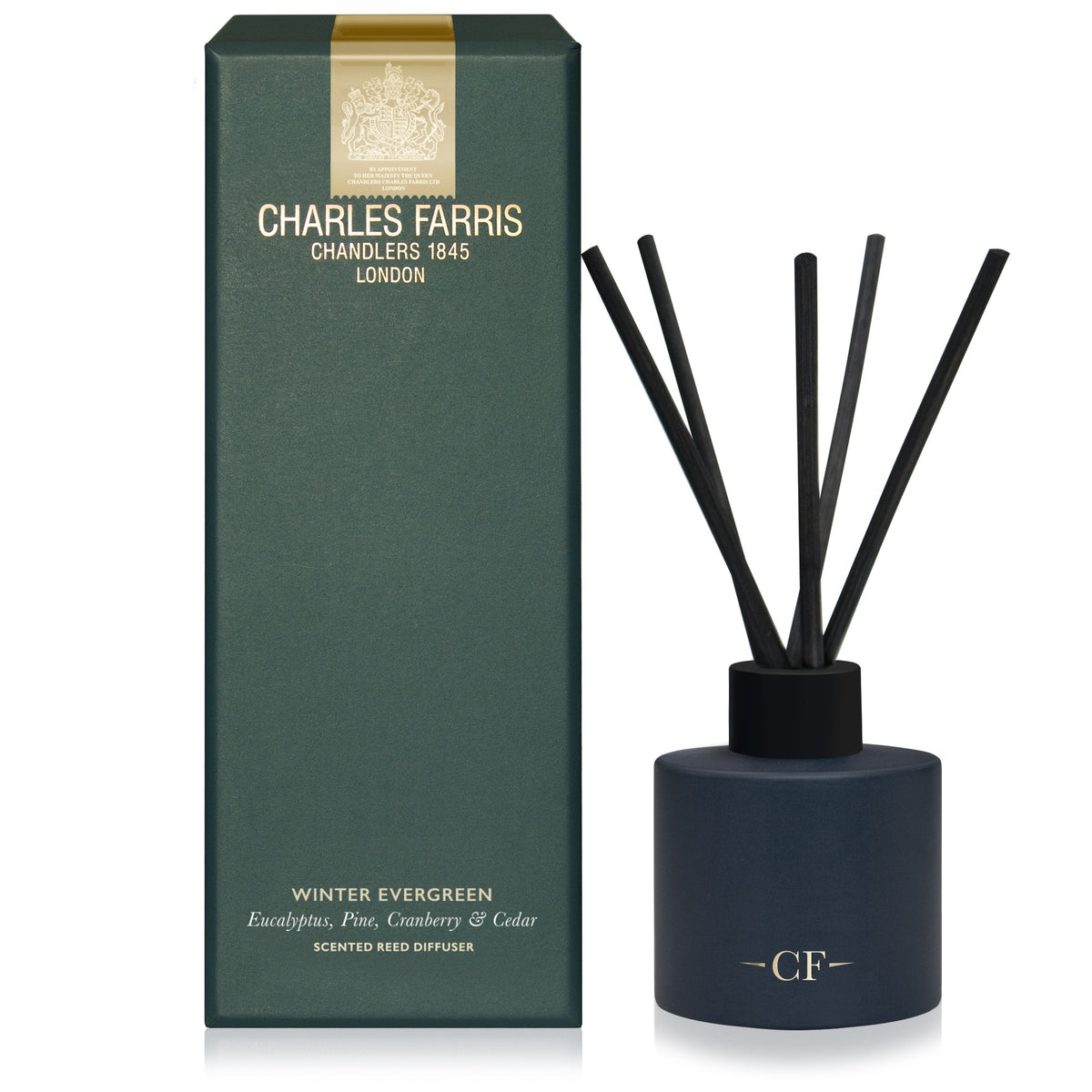 Charles Farris Winter Evergreen reed diffuser in eucalyptus, pine, cranberry and cedar next to it's packaging 