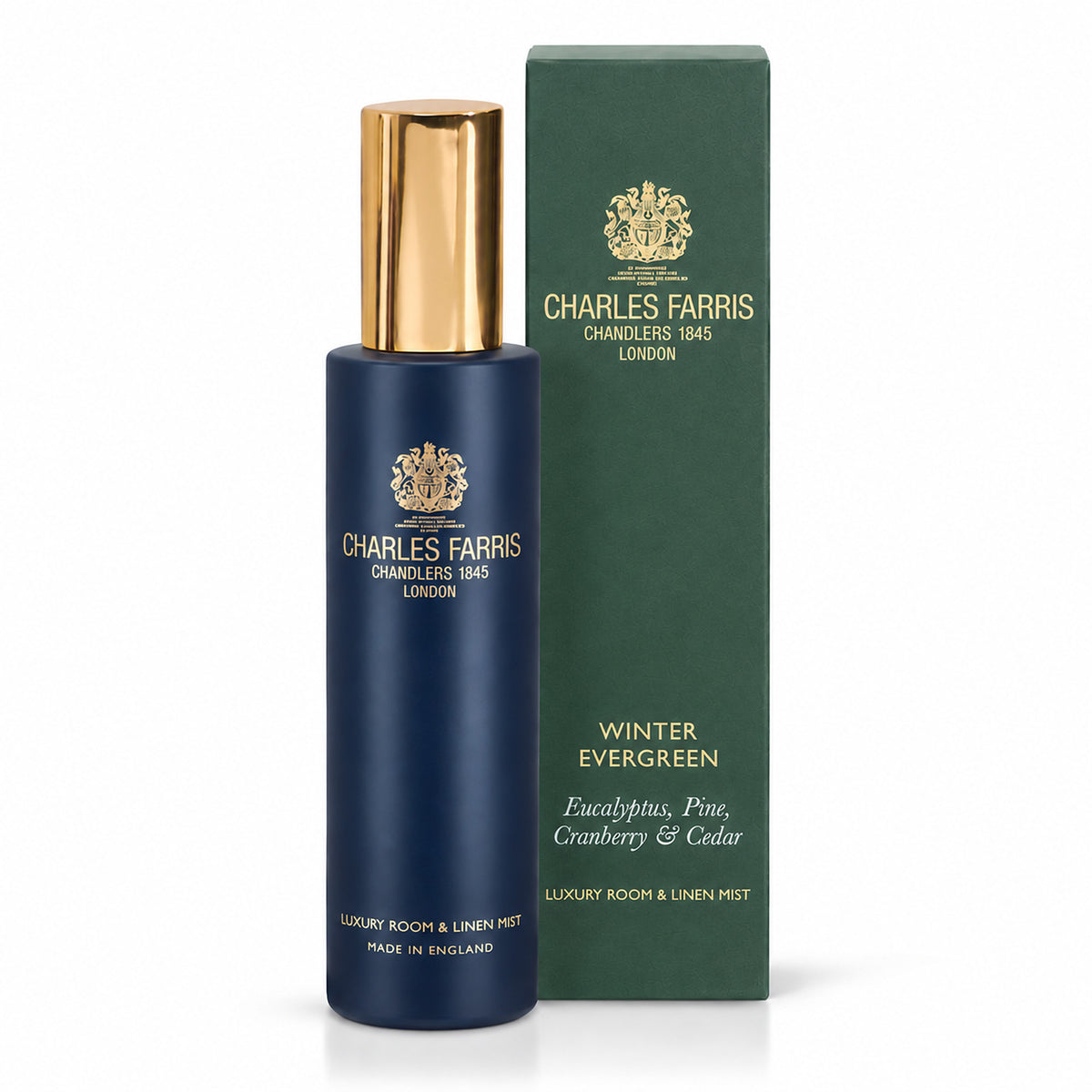 Charles Farris Winter Evergreen eucalyptus, pine, cranberry & cedar room mist scented home spray next to it's green packaging.