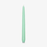 green coloured tapered candle